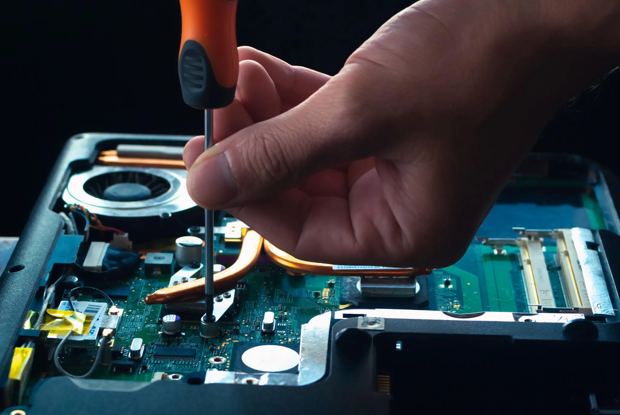 White-gloved hands working inside an open desktop PC during component-level service
